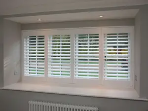 White plantation shutters in a box bay window