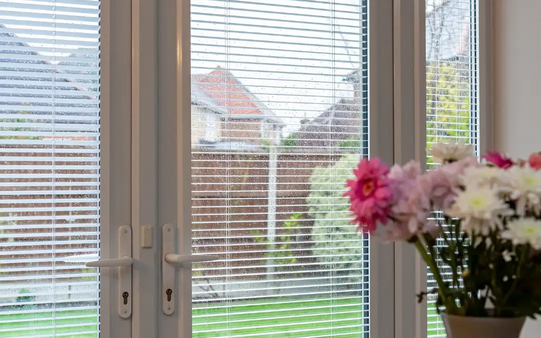 Perfect fit blinds on white French doors overlooking the garden