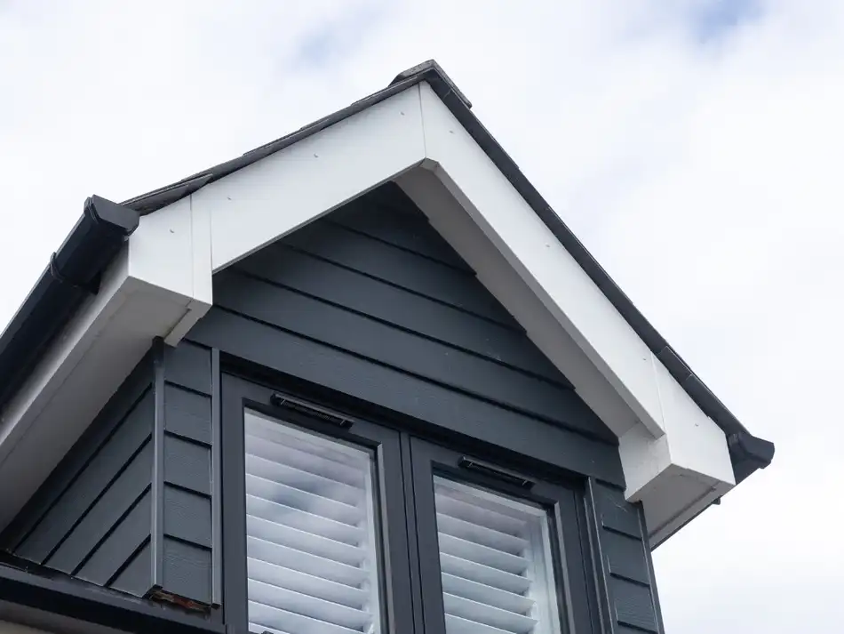 Shutters in a navy-clad dormer window seen from outside