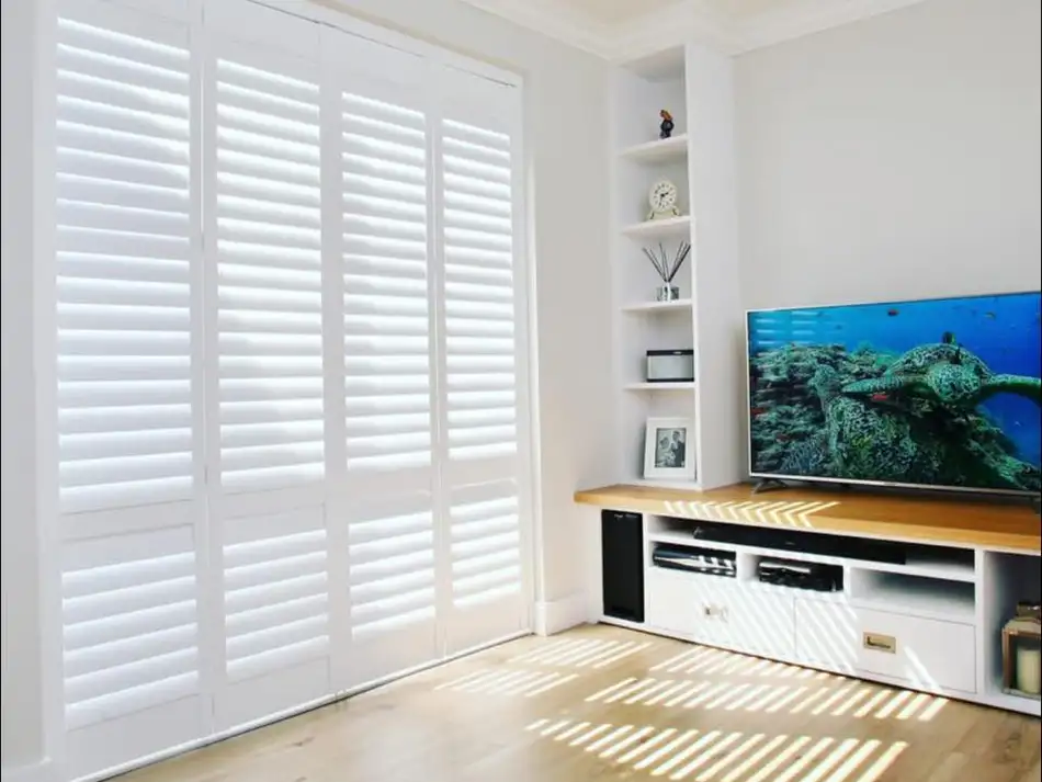 Solid shutters flanking a media wall in a modern lounge