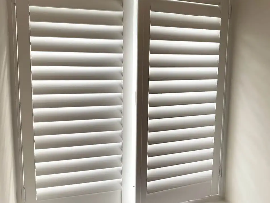 Tier-on-tier shutters in a warm evening living room