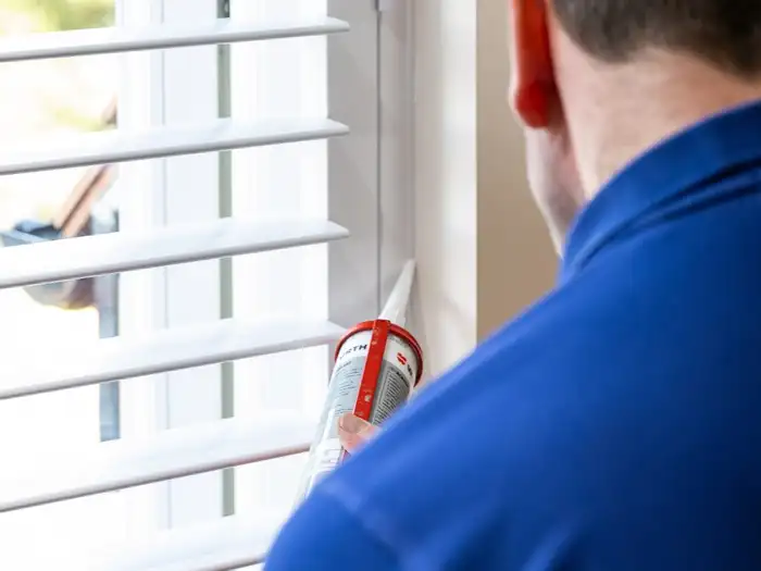 A Lifestyle fitter in the branded polo adjusting the louvres on a new install